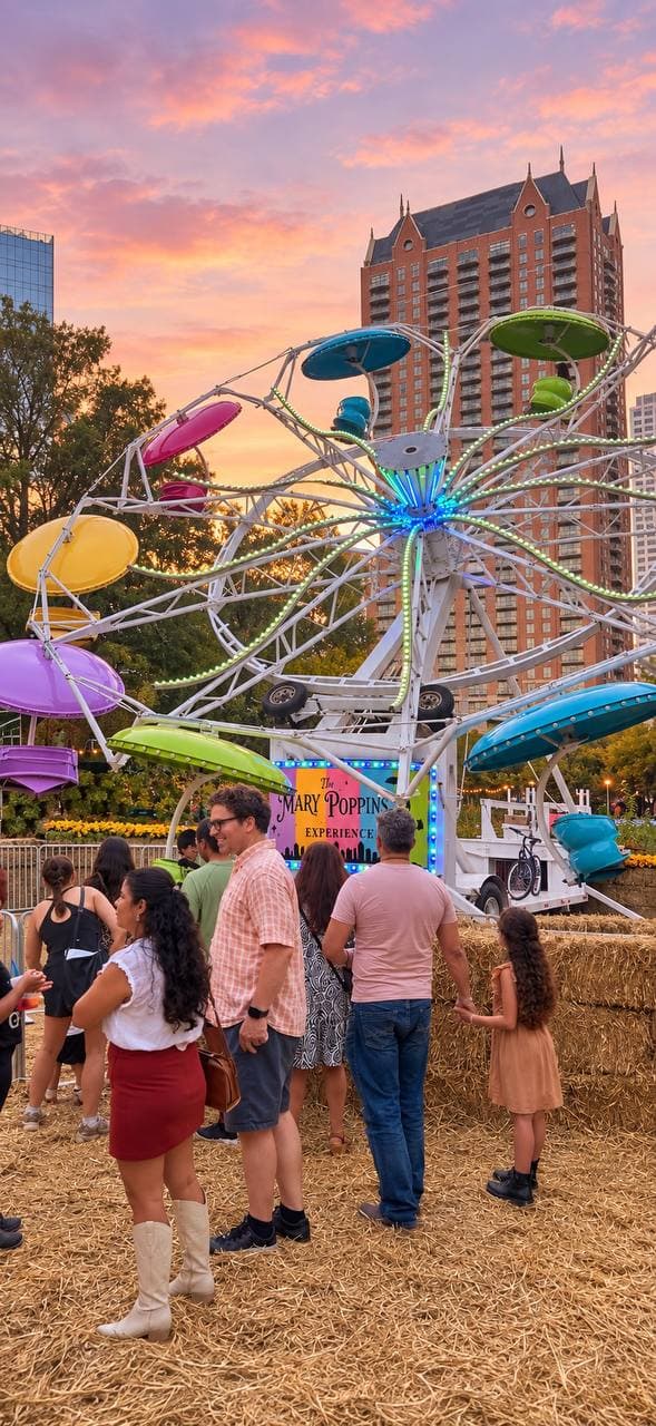Families in line for a lit umbrella-car wheel ride on a bed of hay at sunset